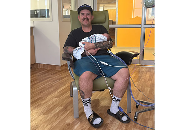 Jonathan holding his son, Porter in the NICU