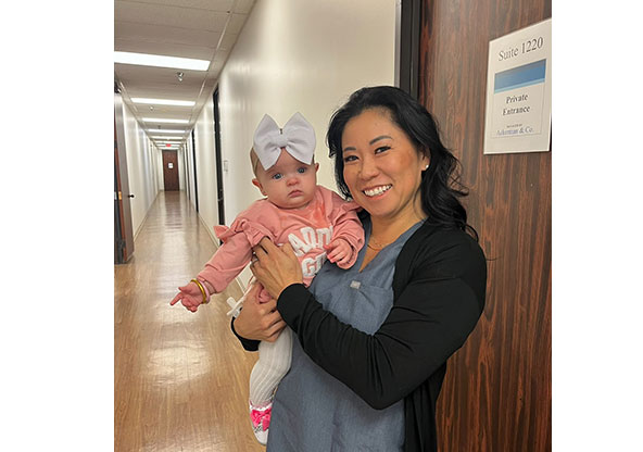 Jana Sullivan, MSN, CNM, is holding baby Emerson Griffiths in the hallway at CHRISTUS Children's.