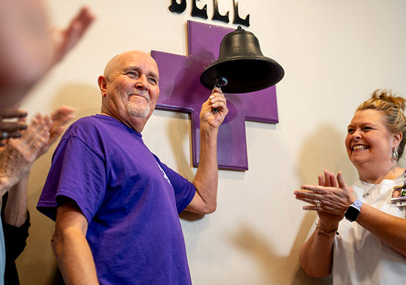 Rick Shaw rings bell at CHRISTUS Health cancer center in Texarkana.