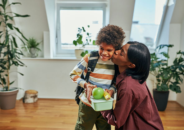 A mother kissing her son 