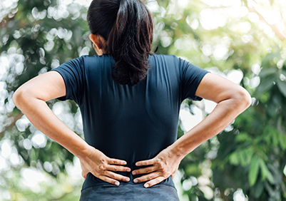 Young lady stretching her back